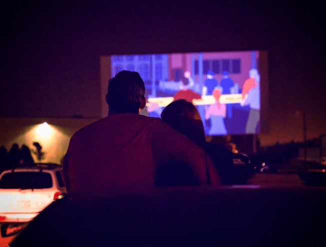 A couple watching a movie at the 88 Drive-In Theater in Commerce City, Colorado.
