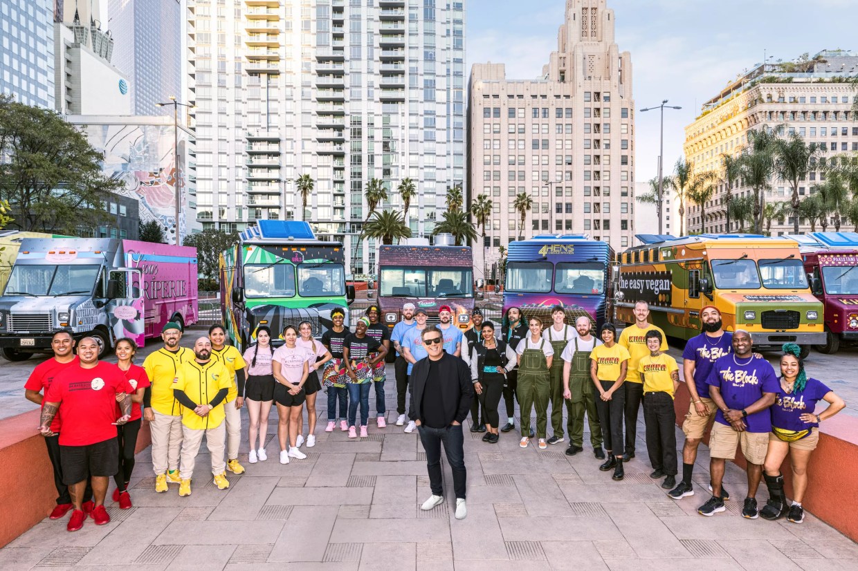 People and food trucks backdropped by LA skyscrapers