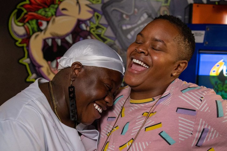 two women embrace and laugh