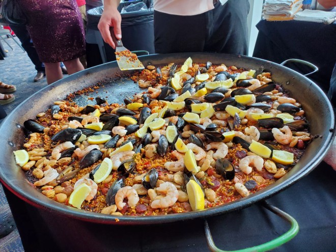 a large pan filled with rise, mussels and shrimp