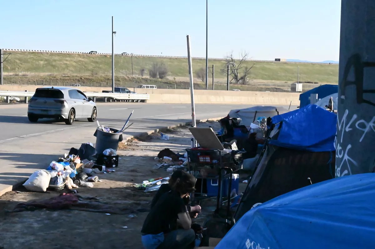 A homeless encampment sits next to Interstate 225 and Parker Road, a popular route through Aurora to Denver.