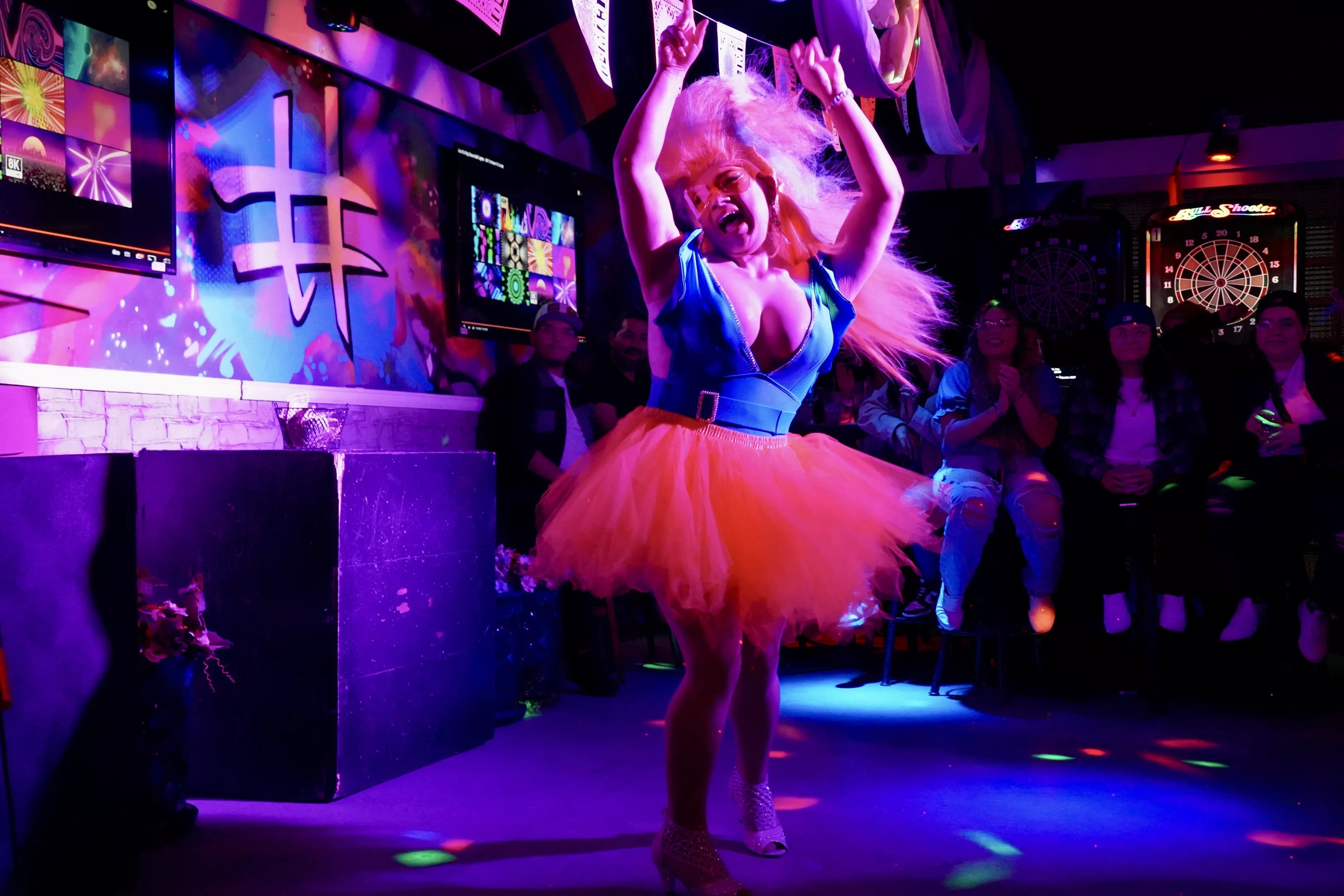 drag queen dances on stage