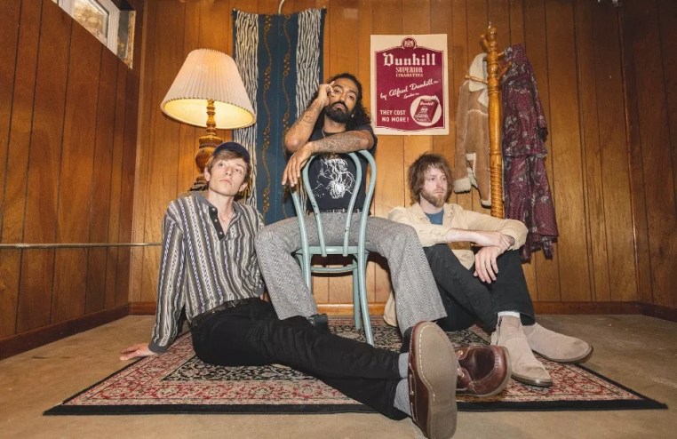 three people sitting in a living room