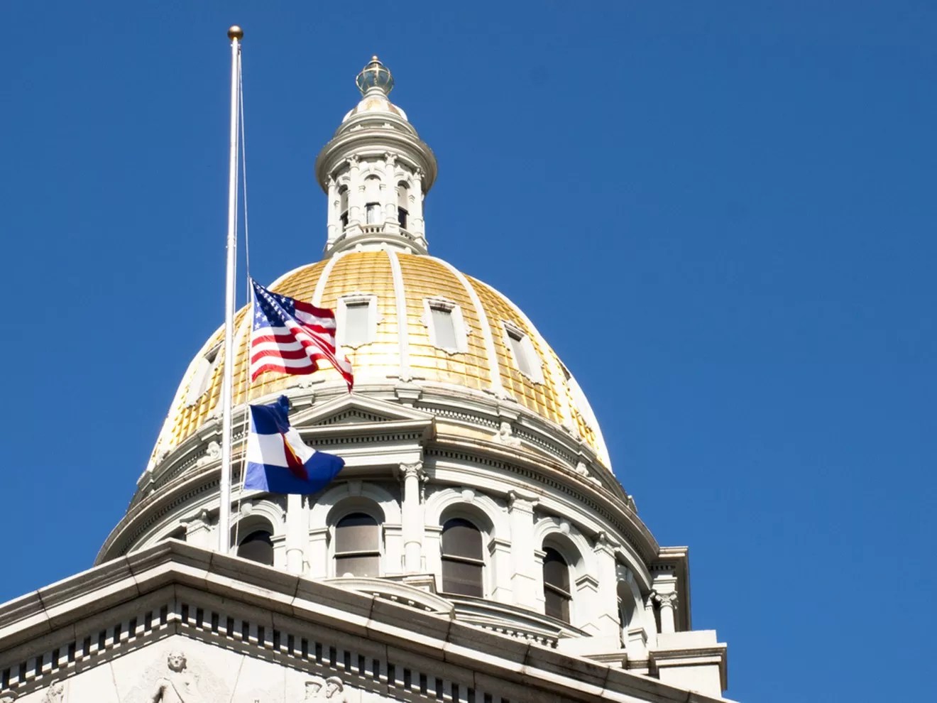 A gold-capped building sits against a blue sky.