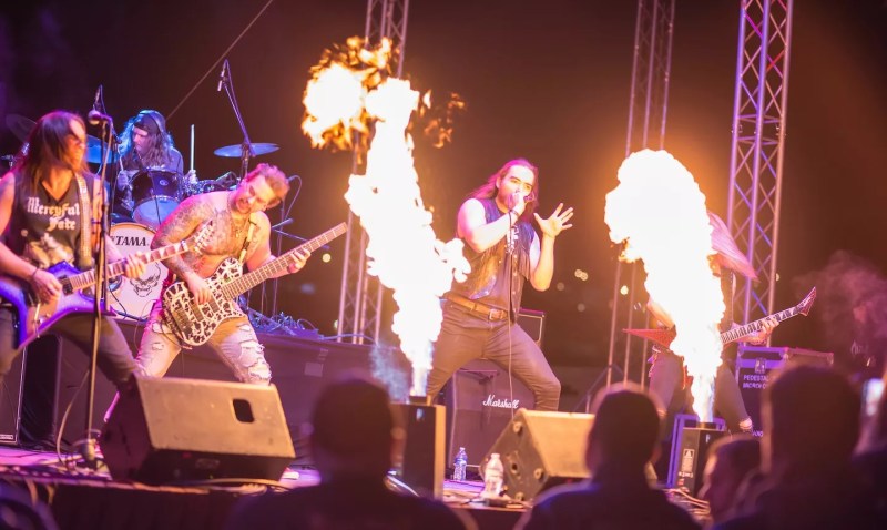 metal band plays on stage with flame throwers