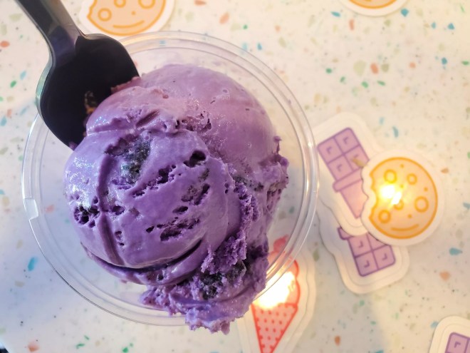 a scoop of purple ice cream in a cup