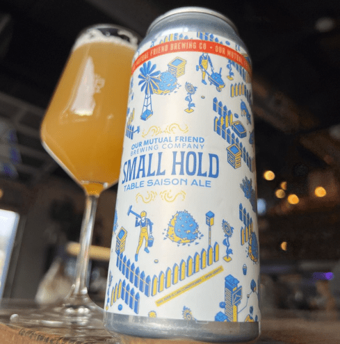 Can of beer in front of a stemmed glass filled with beer