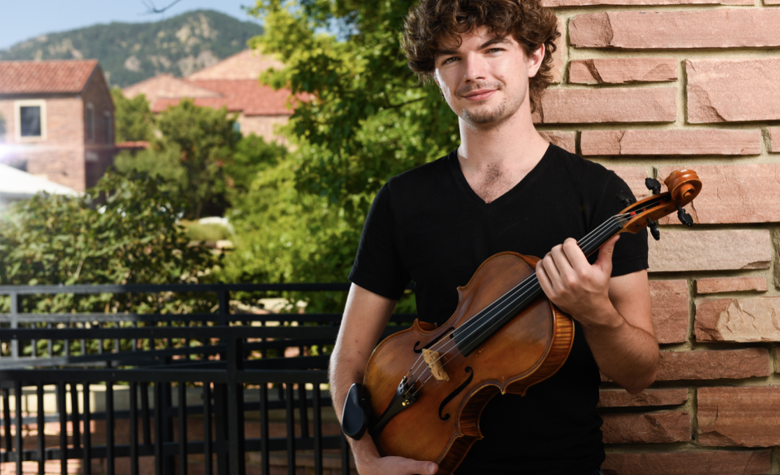 Composer Jordan Holloway poses with his viola.