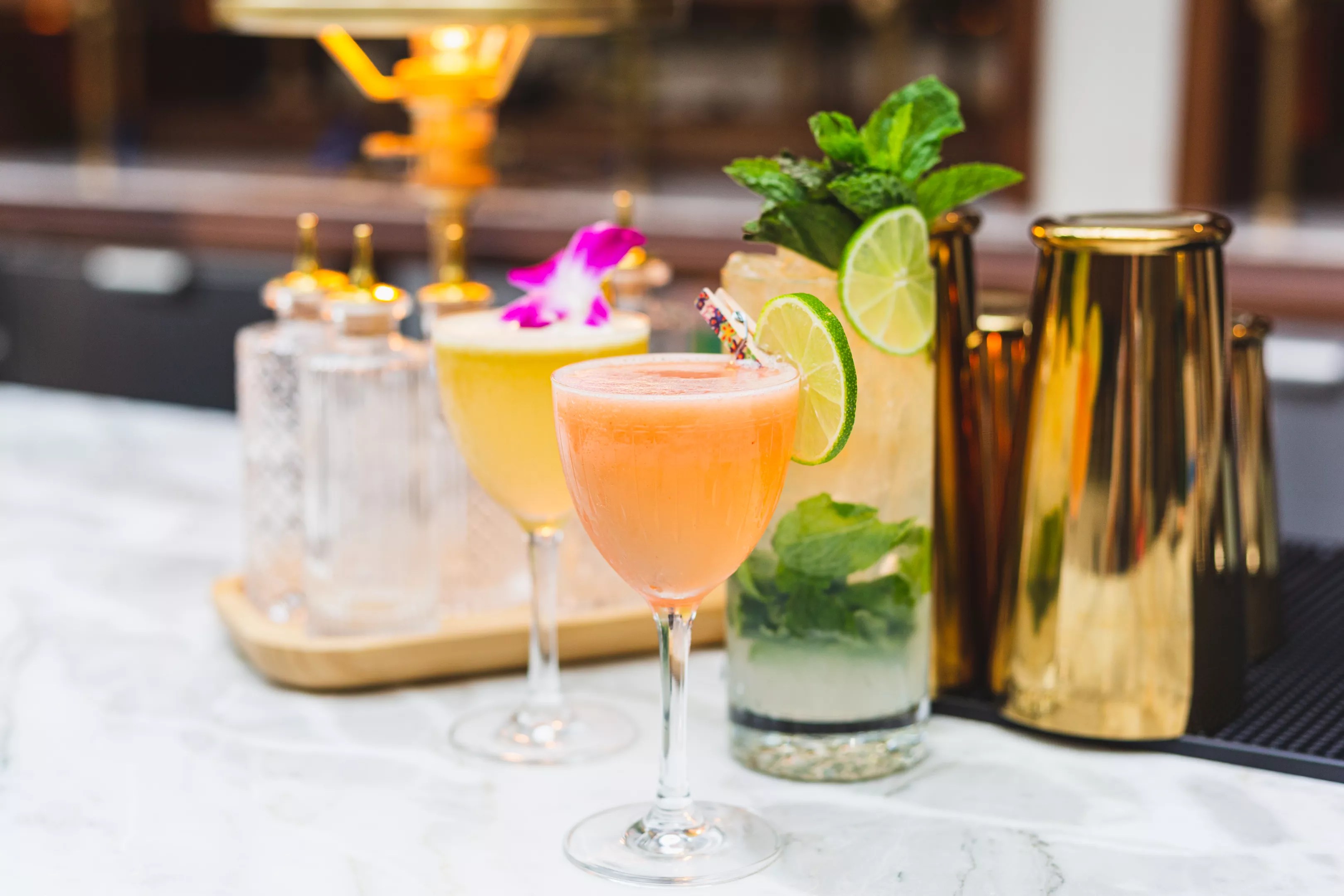 colorful cocktails in glasses on a bar top