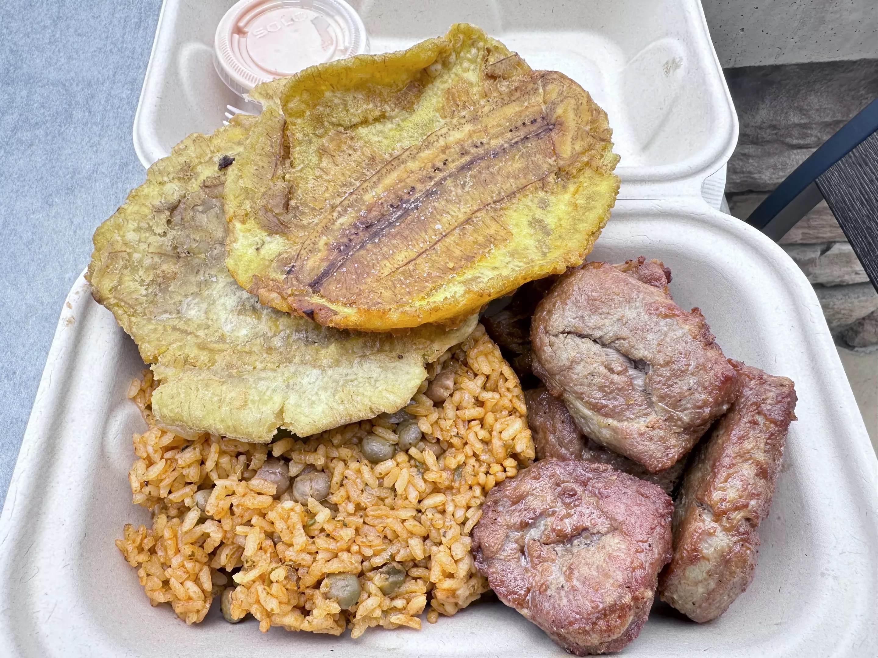 tostones, rice and meat in a to-go box