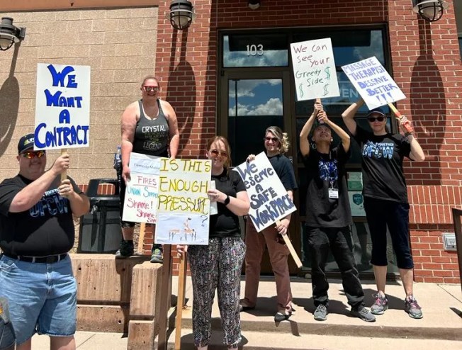 Unionized Elements Massage employees protest their employer's union busting tactics on May 27.
