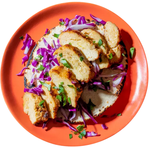 an open pita sandwich on a red plate