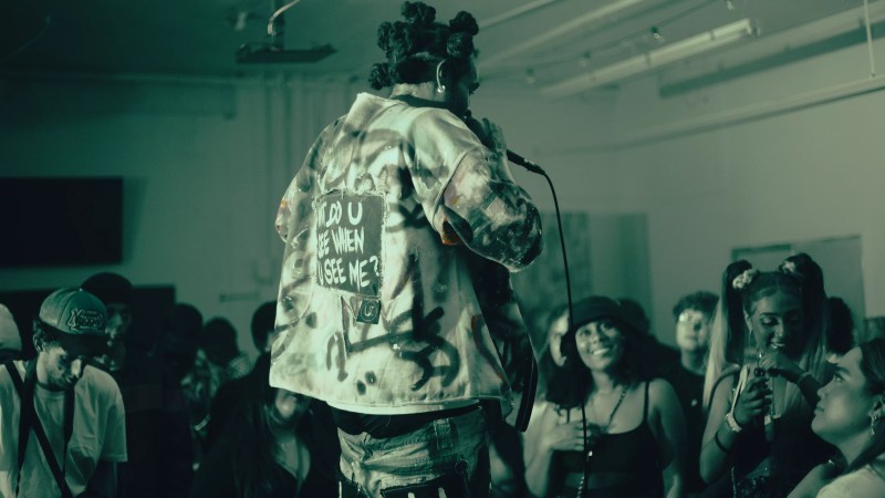 back of a man holding a microphone