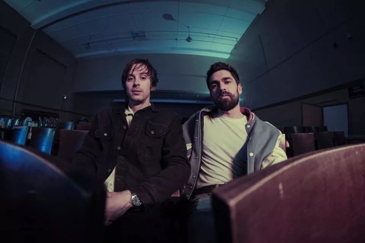 two men in a dark room