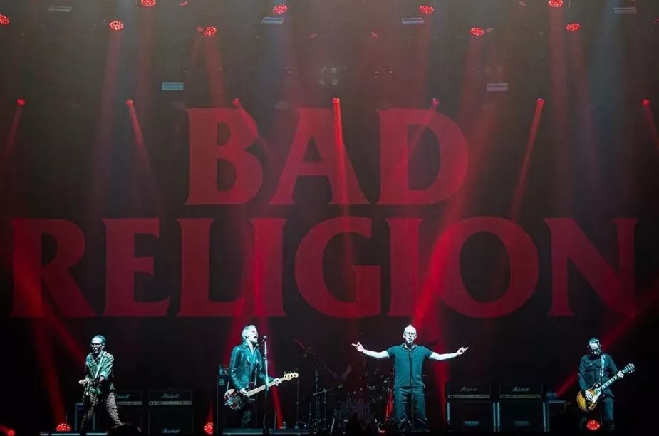 band on stage with red lettering spelling bad religion in the background.