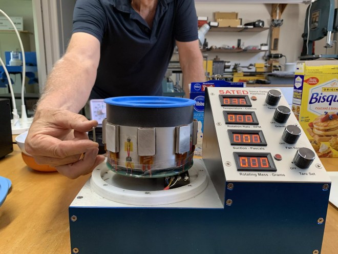 a hand turing a dial on a machine