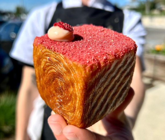 hand holding a cube-shaped croissant