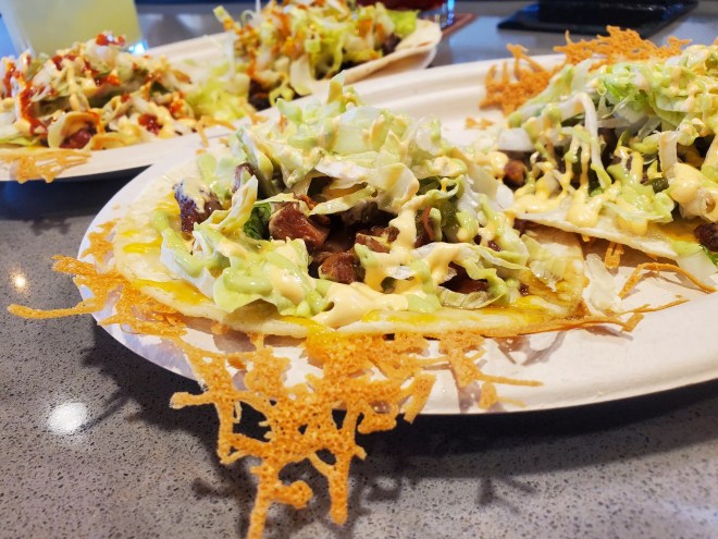 tacos on a plate with crispy cheese around the edges