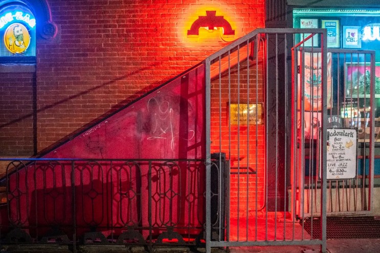 entrance to a basement bar with red light