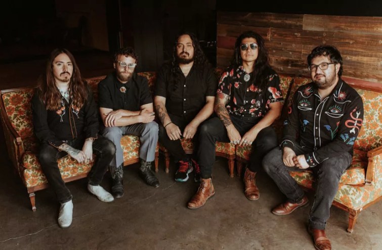 bandmembers sit in a sem-circle