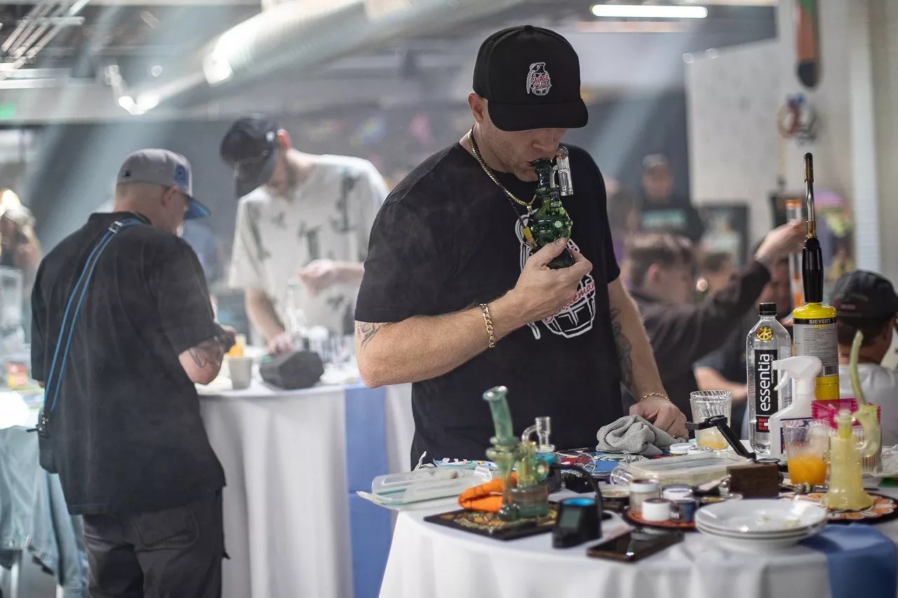A man takes a dab at a cannabis event in Denver