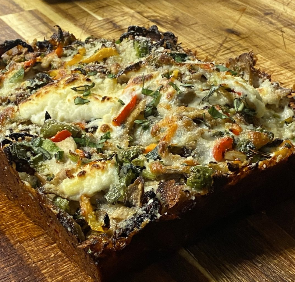 Detroit-style pizza covered in toppings.