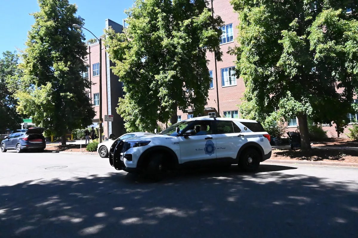 A Denver Police officer pulls out from in front of The Gathering Place at 1535 North High Street.