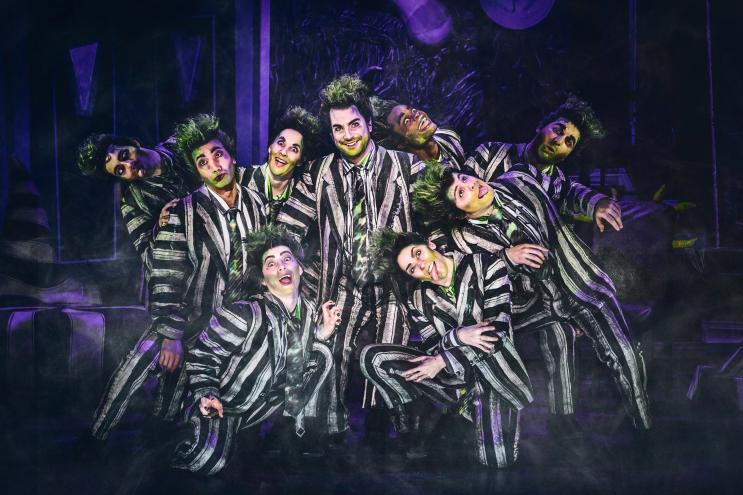 people in black and white striped suits
