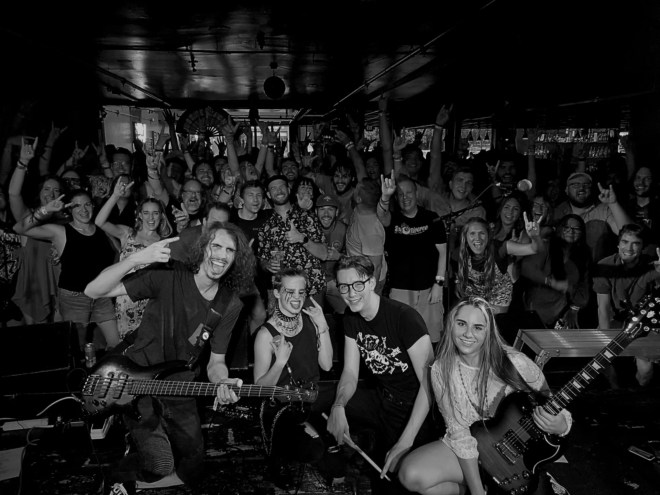 rock band poses with audience