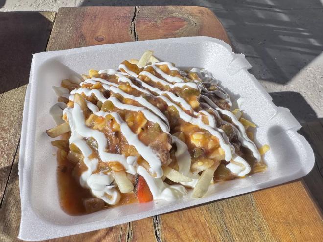 Green Chile smothered fires topped with crema