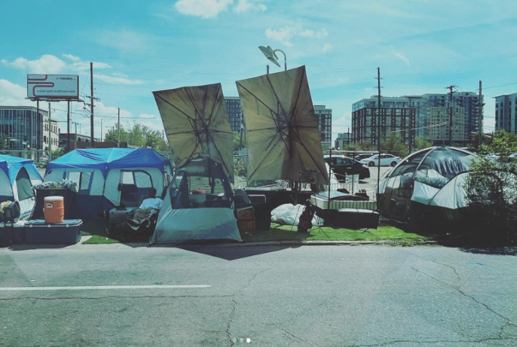 a homeless encampment with large umbrellas