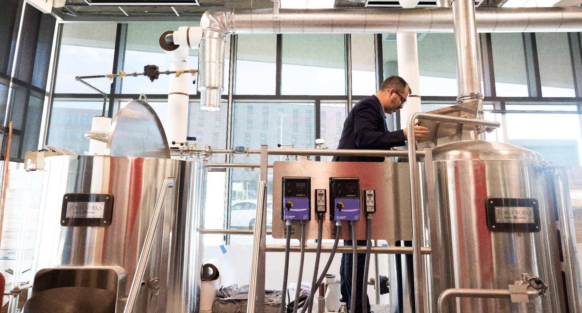 a man standing new brewing equipment