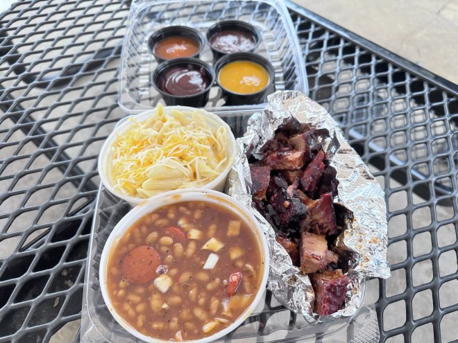 Burnt ends, baked beans, and mac and cheese with a variety of barbecue sauces.