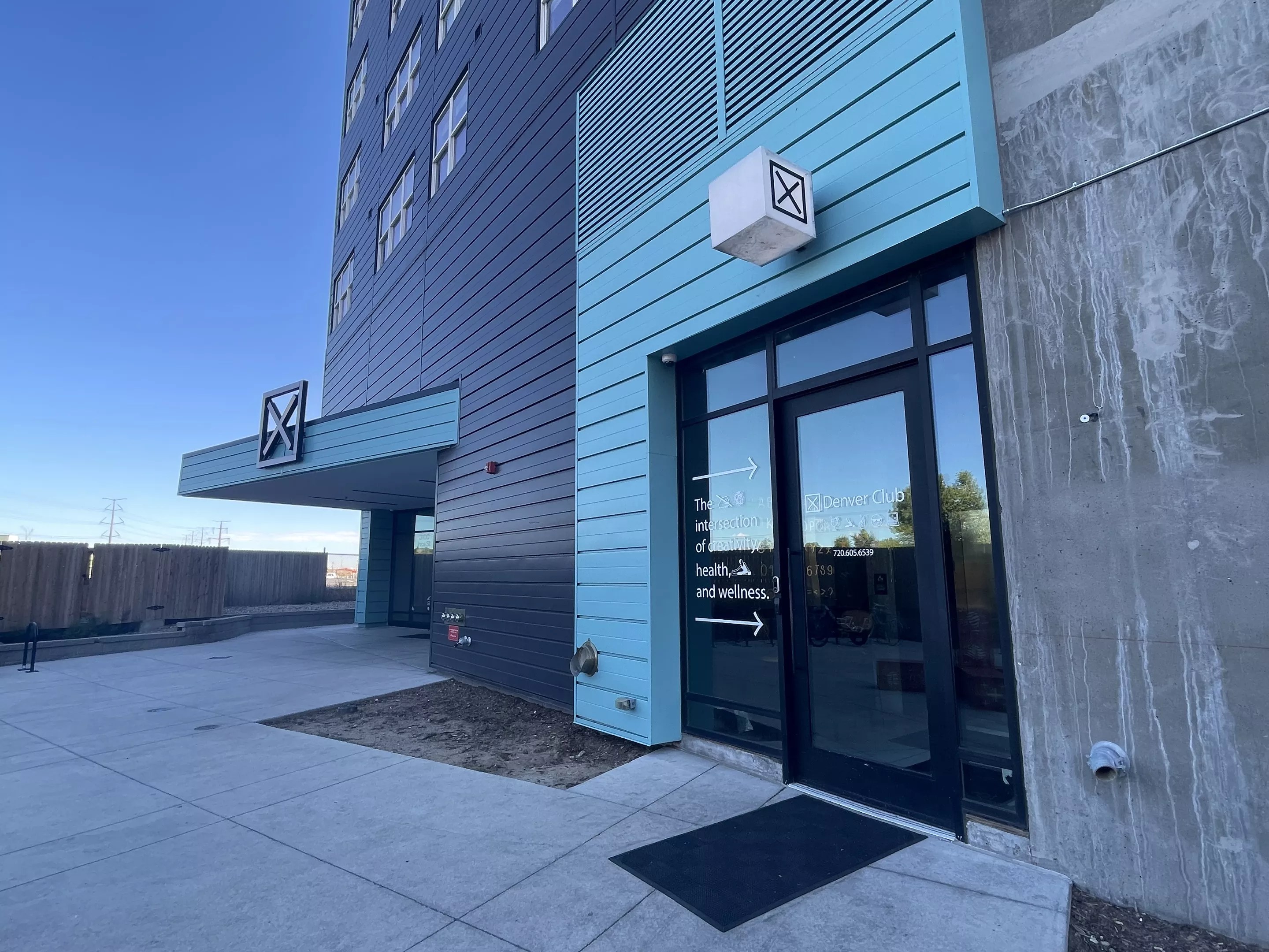 A turquoise and black building.