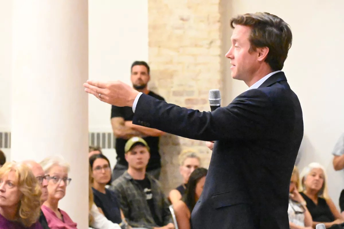 Mike Johnston speaks during a town hall in the Golden Triangle.