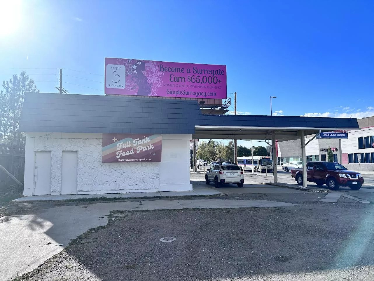 the outside of a building with a car parked under an overhang