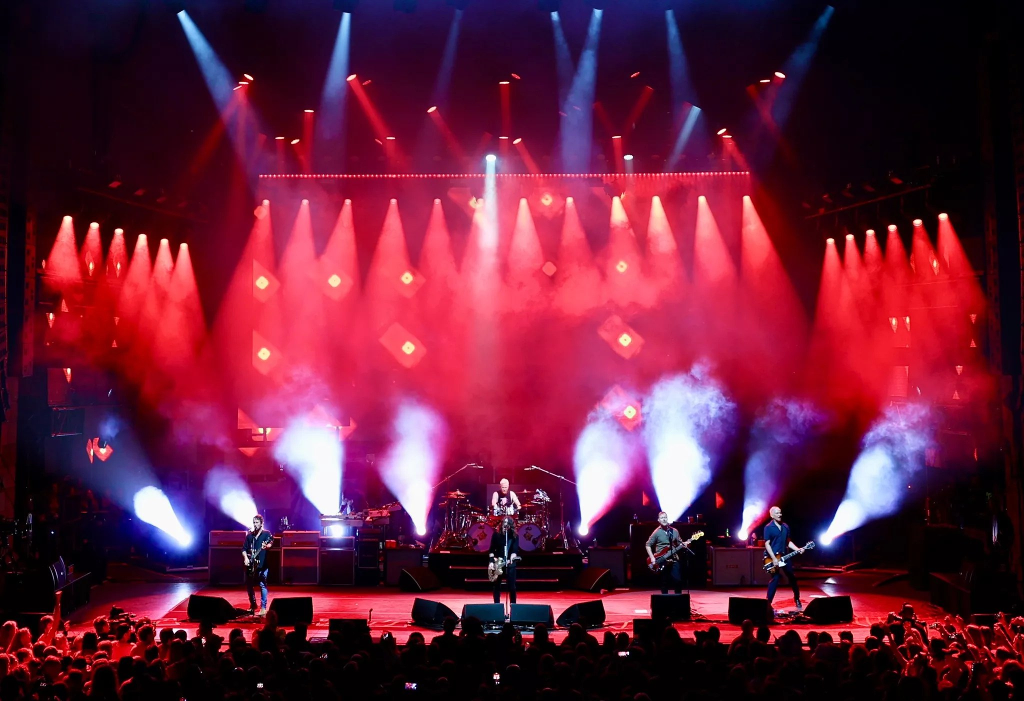band on stage in dark with lights