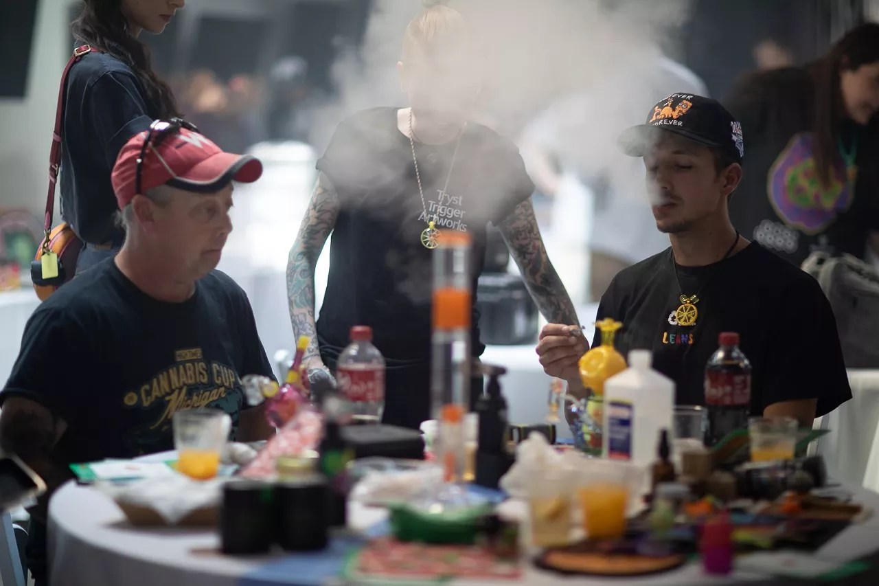 Men smoke weed at a cannabis party in Denver