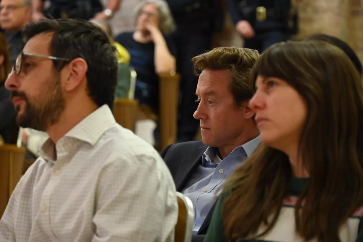 Mayor Mike Johnston sits in the crowd.