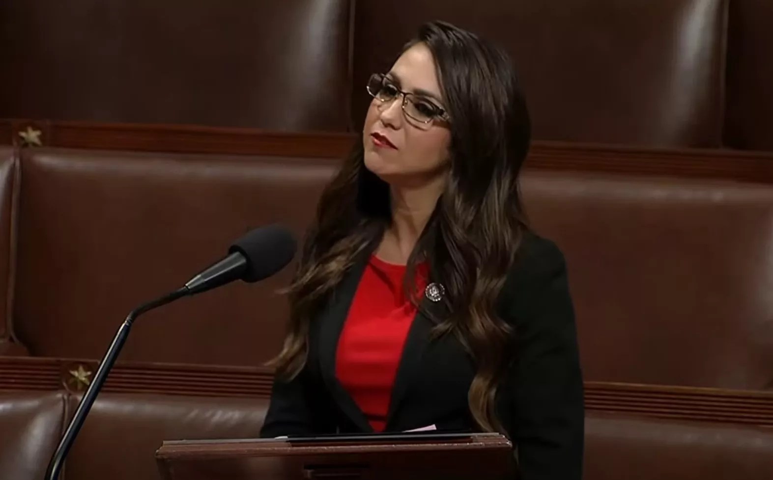 woman in red shirt in Congress