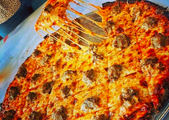 pizza, with a piece taken out