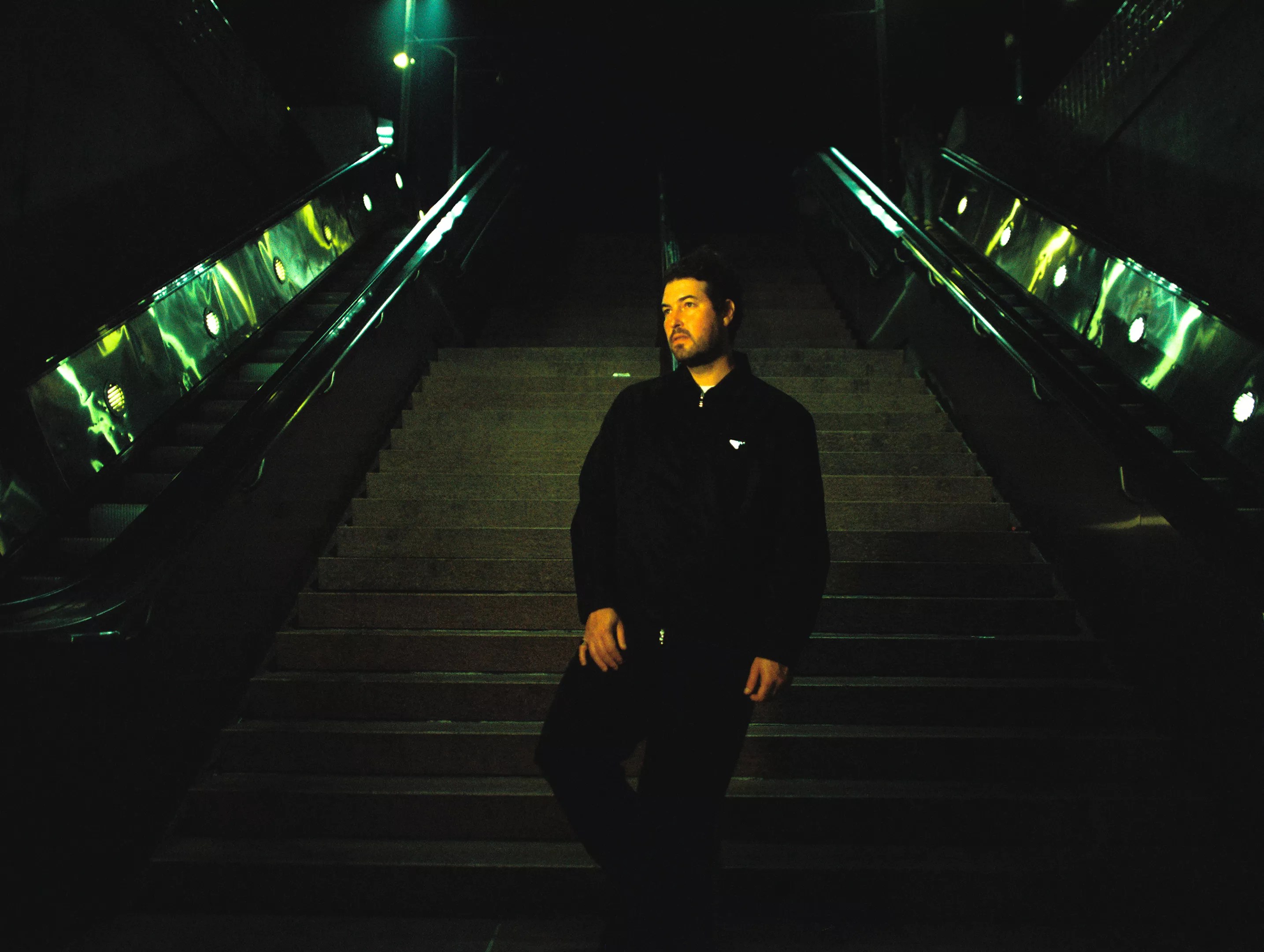 man standing on stairs at night