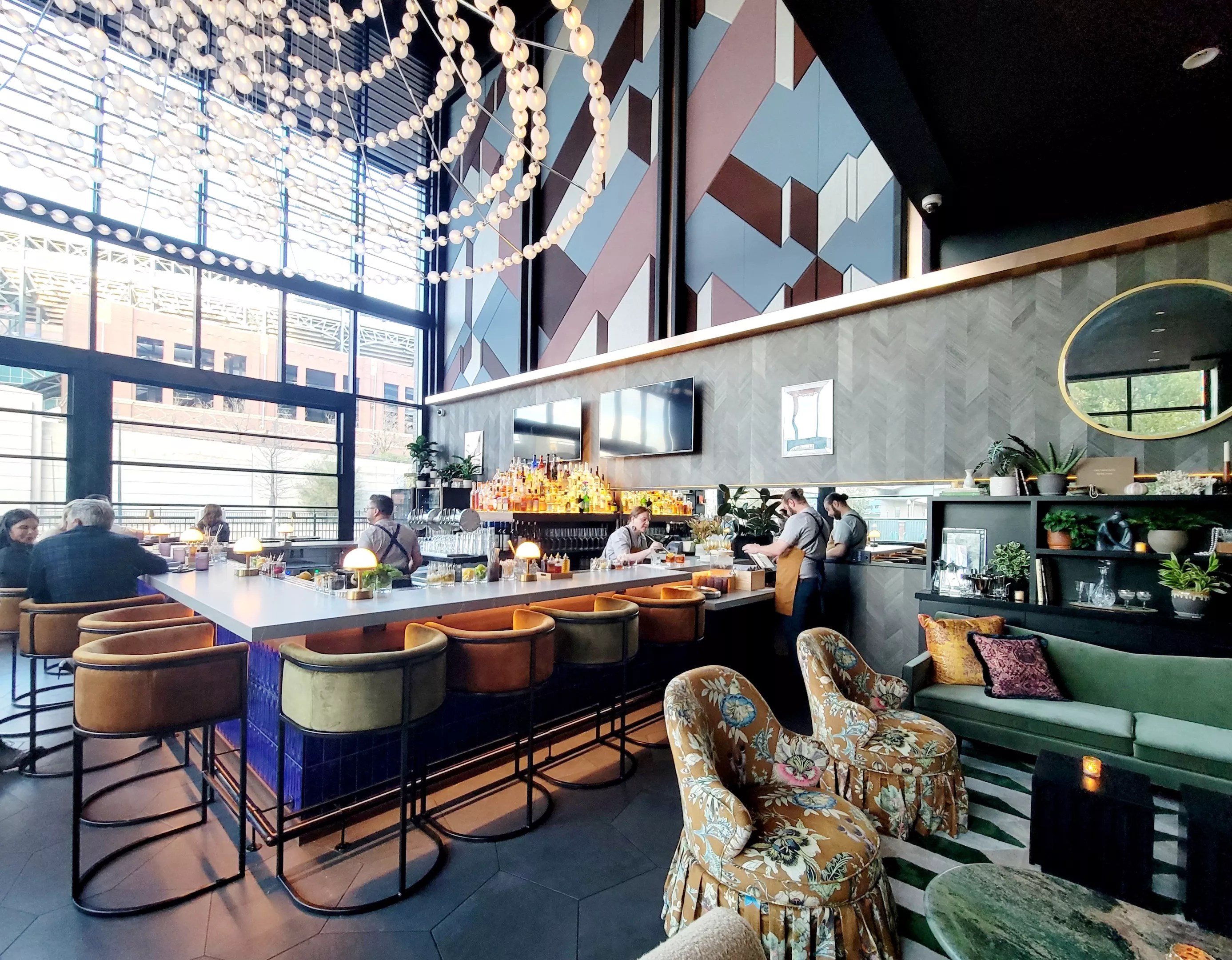 sunlit bar with leather chairs and people sitting