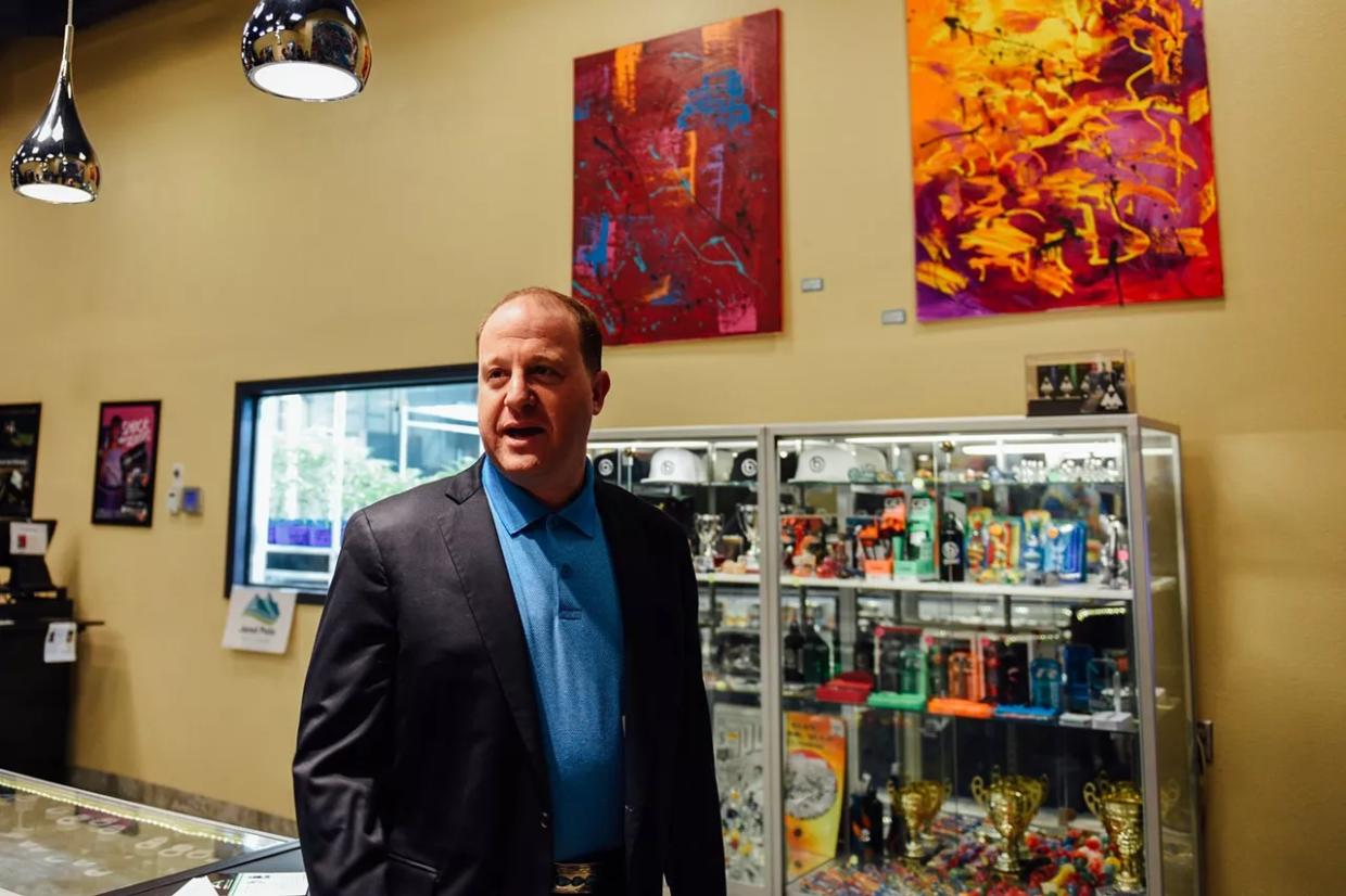 Colorado Governor Jared Polis inside of a marijuana dispensary