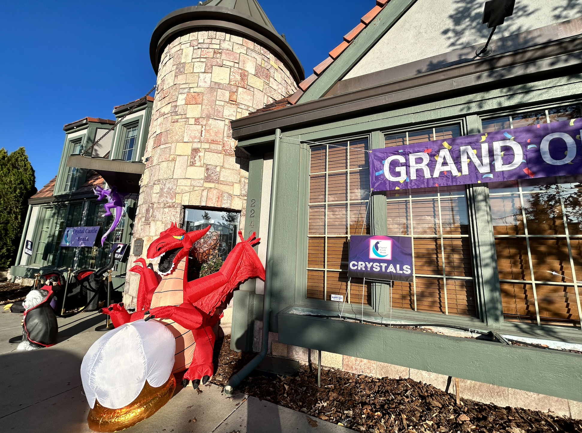 a storefront with an inflatable red dragon outside