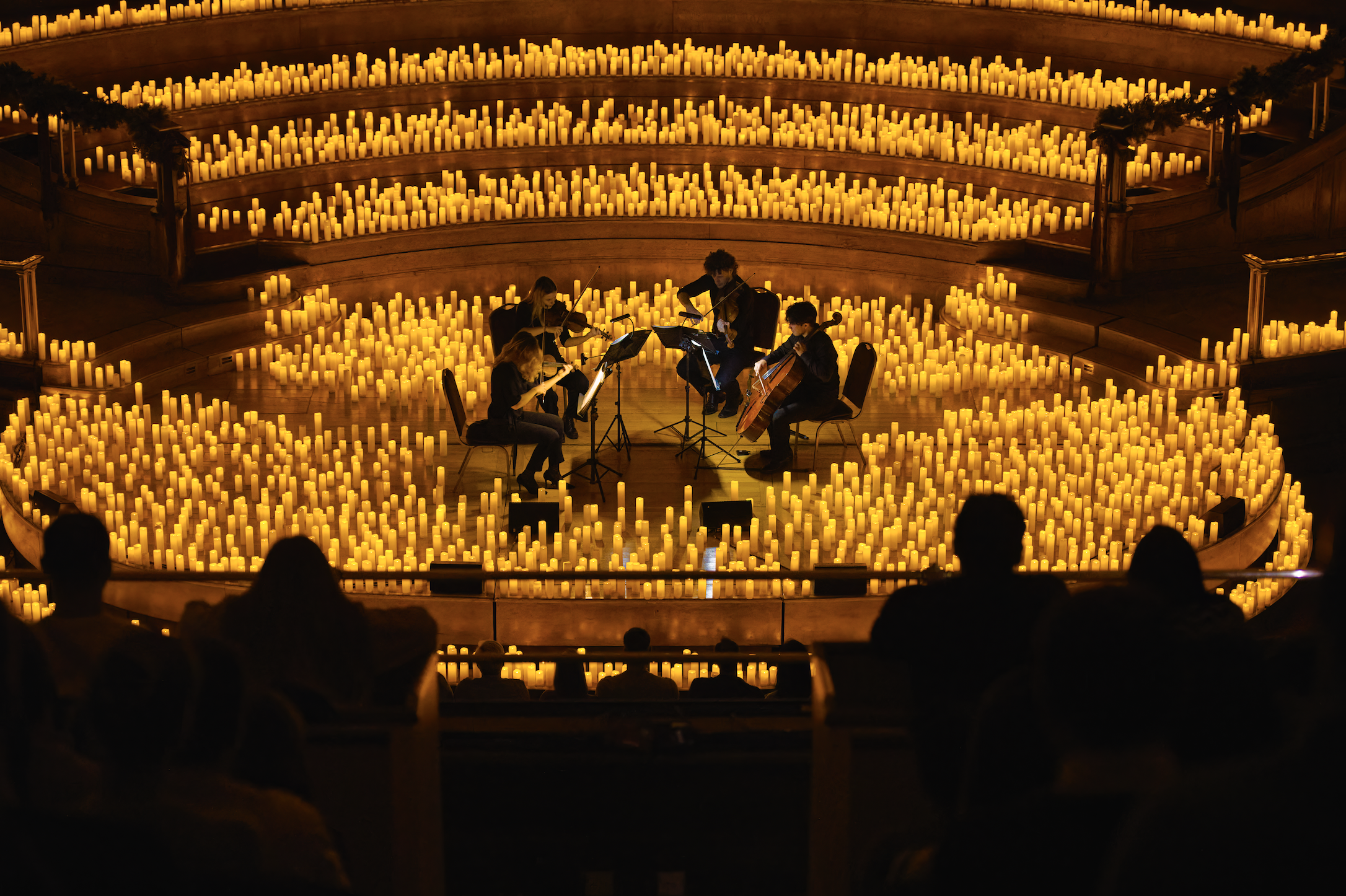 musicians playing instruments surrounded by candles
