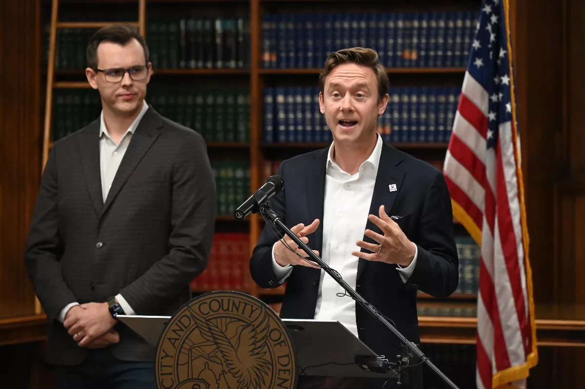 Mayor Mike Johnston and Will Goodale from Housing Connector speak at a press conference.