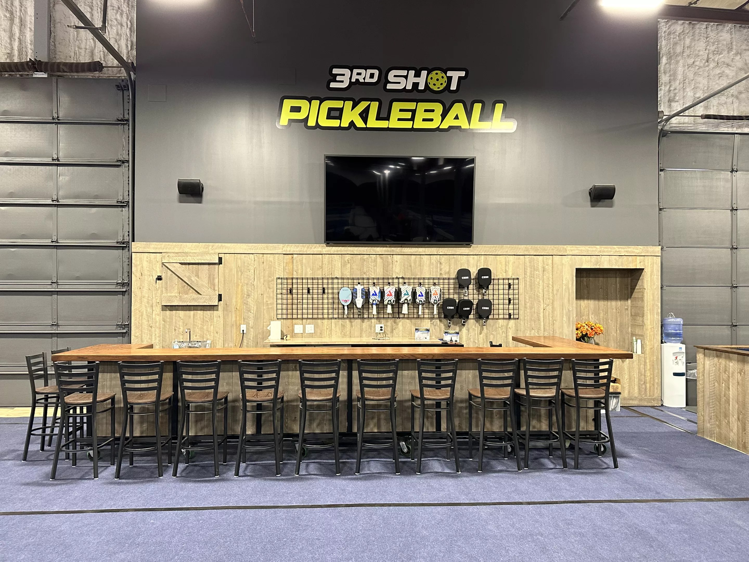 stools lined up in front of a large table indoors