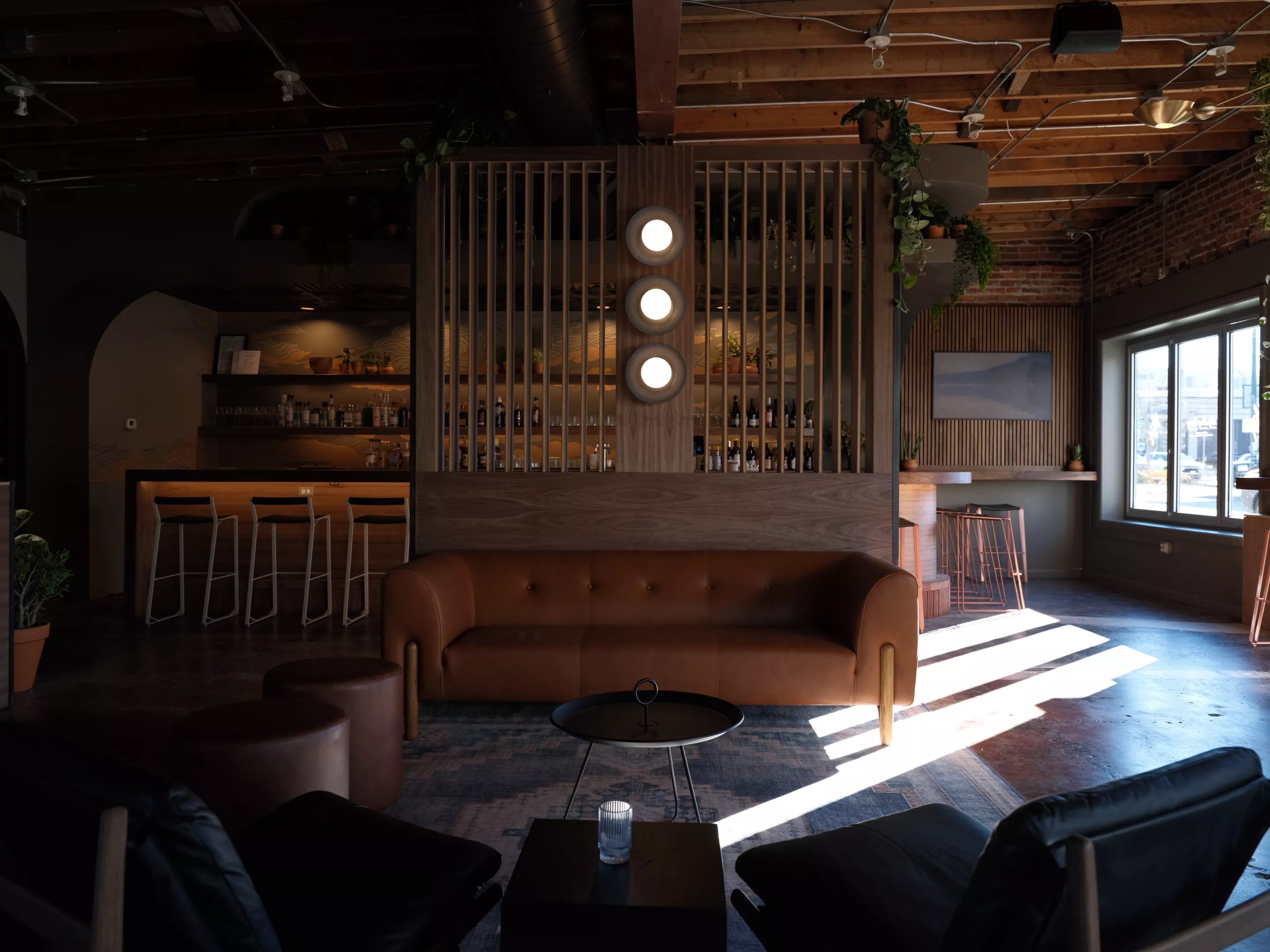 interior of a bar with a brown couch in front of it