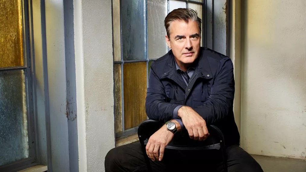 Actor Chris Noth sits in a chair